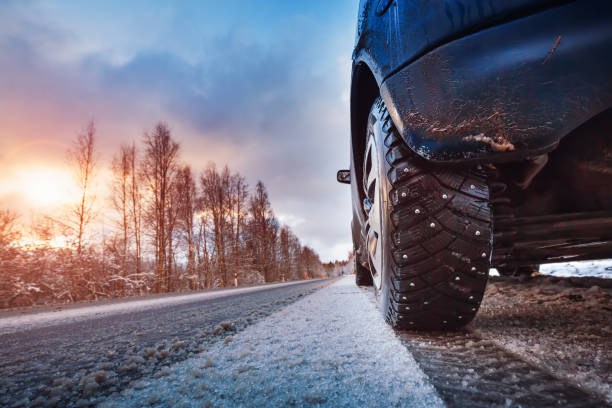 istock Car tires on winter road covered with snow 1282875856