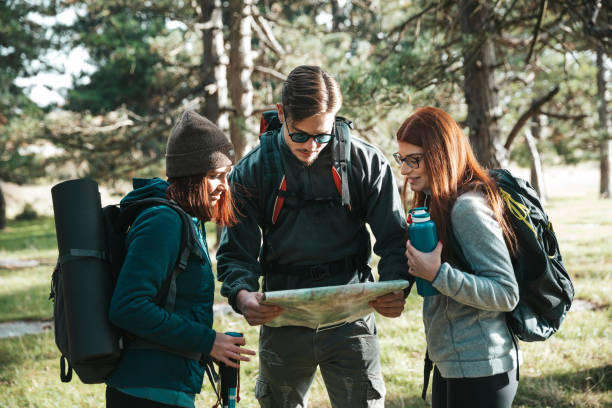 istock Friends on a hike reading the trails map 1282875923