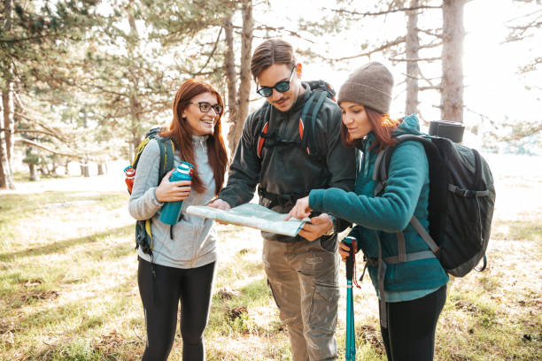 istock Friends on a hike reading the trails map 1282876033