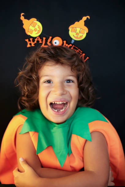 istock Cute kid in halloween costume scaring pose. 1282876381