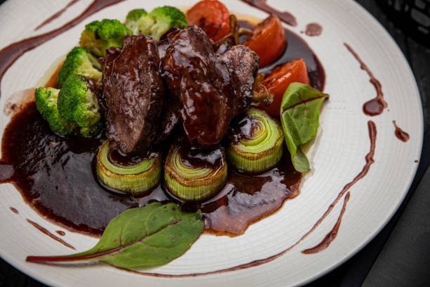 istock Grilled veal with sauce on a dark table 1282876430