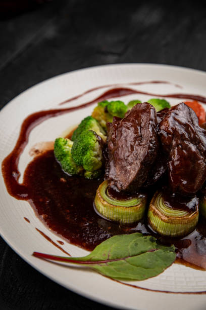 istock Grilled veal with sauce on a dark table 1282876487