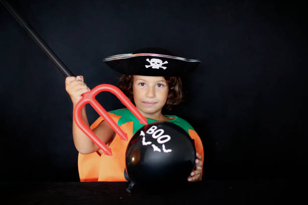 istock Cute kid in halloween costume scaring pose. 1282877172