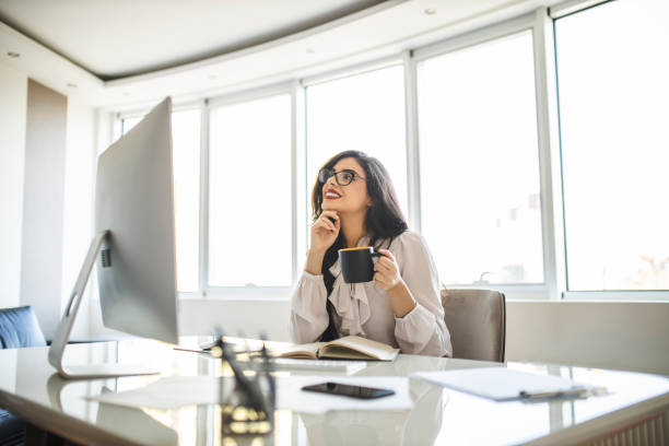 istock Businesswoman working and drinking coffee in her office 1282877752