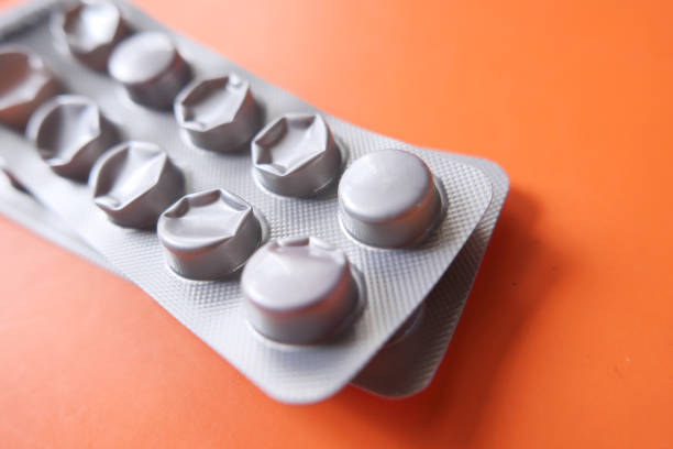 Pills in foil blisters close-up on a white background