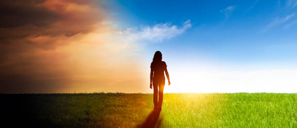istock Woman in a landscape with from darkness into the light 1282877991