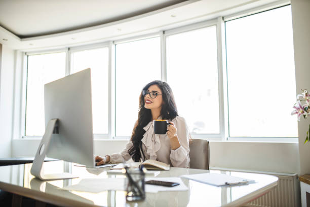 istock Businesswoman working and drinking coffee in her office 1282878074