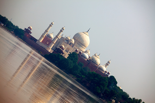 A different oblique perspective of the grand Taj, with a huge, shimmering span of the Yamuna river right in front.