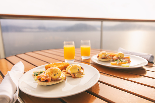 Cruise ship vacation food breakfast on suite balcony table in room service. Caribbean travel getaway, winter escape or honeymoon cruise in Europe or Santorini.