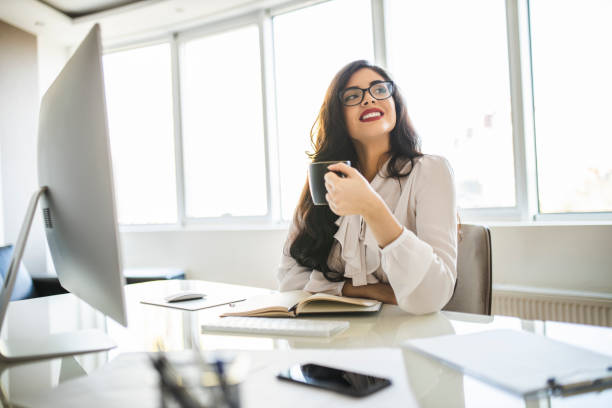 istock Businesswoman working and drinking coffee in her office 1282880326
