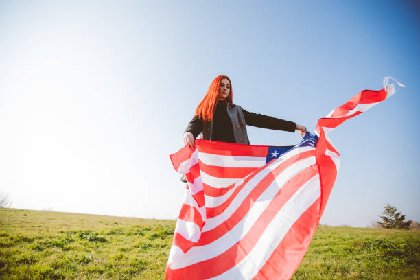istock Young redhead spreading American flag 1282880431