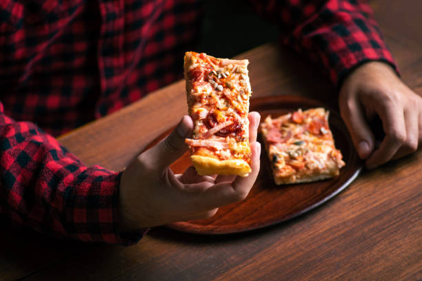istock man eating a homemade pizza at home 1282880533