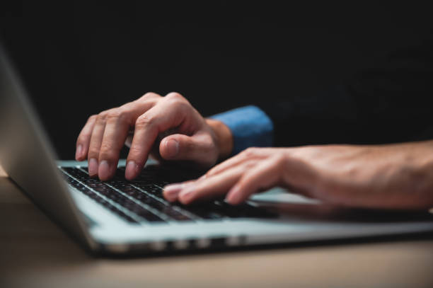 istock handsome confident businessman in suit working with laptop 1282880714