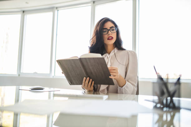 istock Serious woman working in her office, reading and checking documents 1282882069