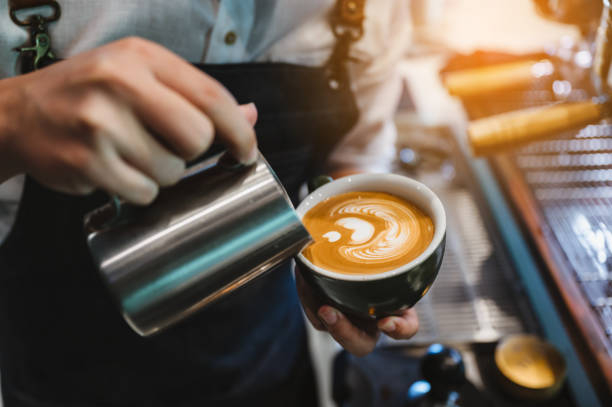 barista making latte art, shot focus in cup of milk and coffee, vintage filter image - cappuccino imagens e fotografias de stock