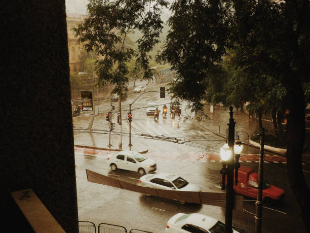 Cars driving on a wet road in the rain, at Sao Paulo's downtown.