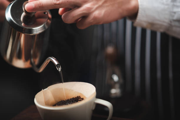 istock Hand drip coffee filter, barista pouring hot water on roasted coffee ground with filter 1282882962