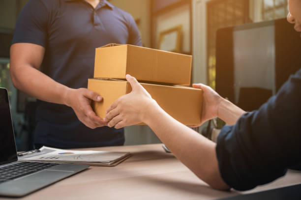 istock parcel delivery with good depth of field. Friendly worker with high quality delivery service. 1282883613