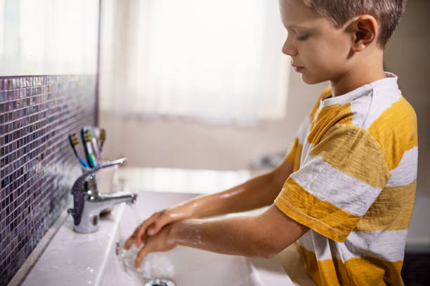 istock Little boy washing hands thoroughly 1282884810
