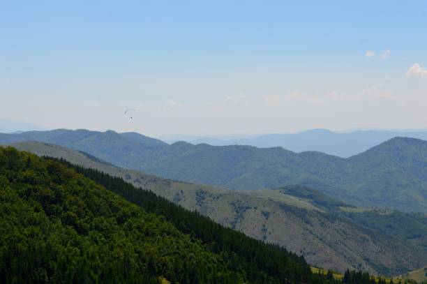 istock a paraglider flies over mountain peaks 1282885127