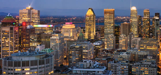 istock Downtown Montreal panoramic view at night featuring skyscrapers and the Saint-Lawrence River 1282885910