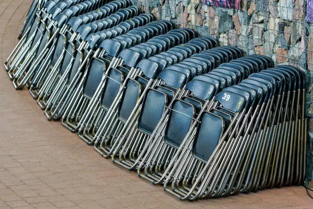 Photo of a large stack of folding chairs in the concert hall