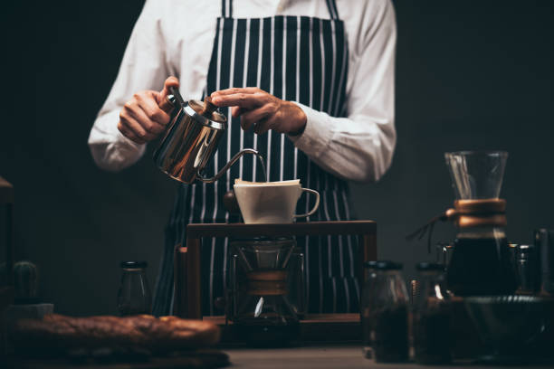 istock Hand drip coffee filter, barista pouring hot water on roasted coffee ground with filter 1282888557