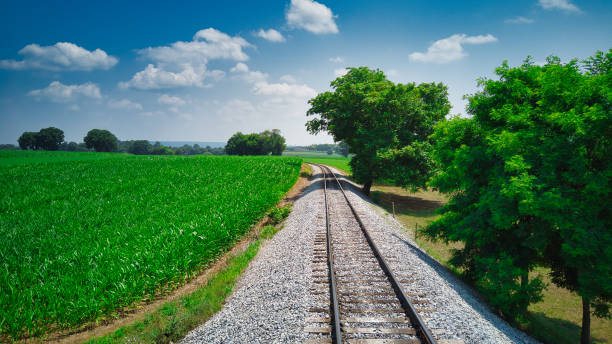 old rail road track going thru countryside - railroad spikes fotografías e imágenes de stock