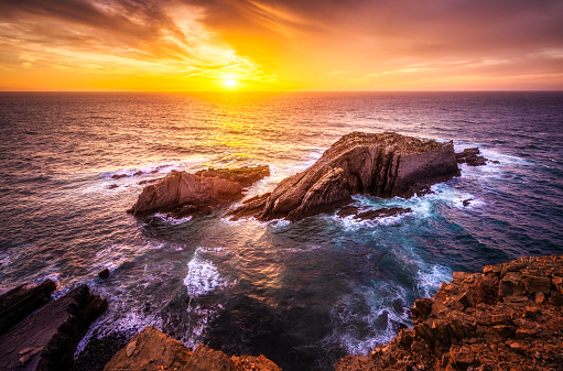 epic sunset over atlantic sea at Ponta da Atalaia, Vicentine Coast, Aljezur, Algarve, Portugal