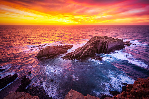 epic sunset over atlantic sea at Ponta da Atalaia, Vicentine Coast, Aljezur, Algarve, Portugal