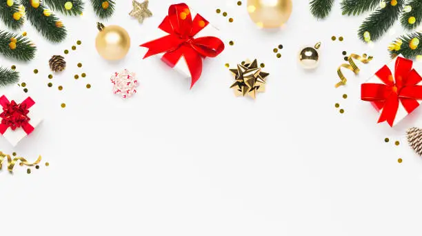 Photo of Merry Christmas and Happy Holidays greeting card background with copyspace in the bottom. Christmas gifts and decor on white background top view. Winter xmas holiday theme in flat lay