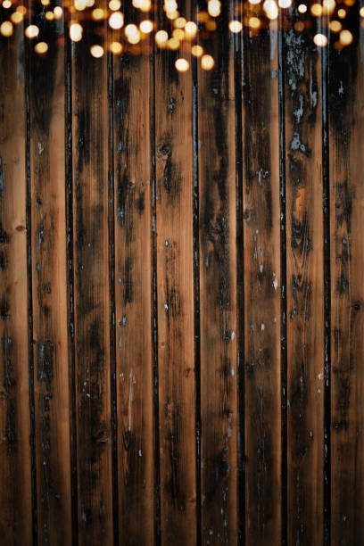 istock Shabby board wall with bokeh lights 1282892570