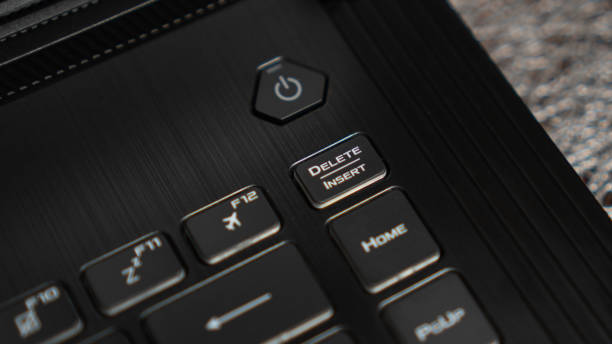 istock Close up the Delete key on the laptop keyboard. Insert key on keyboard. Modern black keyboard 1282896798
