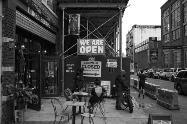 Hanging out at Dumbo Square on Jay Street Brooklyn, NY, USA - Oct 29, 2020: A local Asian Fusion restaurant next to construction work with appropriate signs all mixed together with customers using outside dining because of the pandemic warren street brooklyn stock pictures, royalty-free photos & images