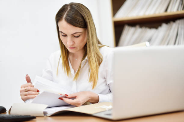 istock Middle aged woman office manager looking for office documents in the office 1282897100