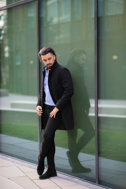istock Handsome young man leaning against a glass fassade 1282897255