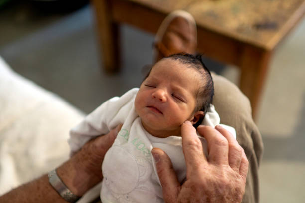 istock grandfather with newborn baby 1282898218