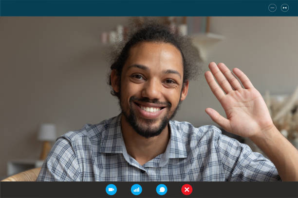 istock Smiling ethnic man wave talking on webcam call at home 1282899228
