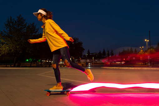 nice caucasian blonde model free woman with a skateboard. woman with a skateboard. long exposure night