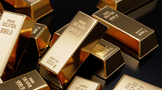 Gold bars laying on black background. Horizontal composition with copy space. Wealth and finance concept.
