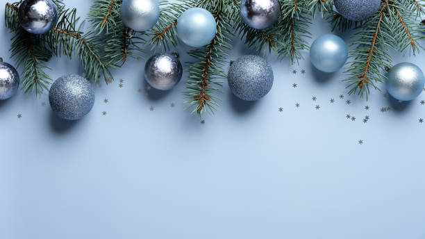 istock Christmas banner mockup. Flat lay, top view blue and silver balls decoration with pine tree branches on pastel blue background. Christmas, New year, winter holiday celebration concept. 1282904372