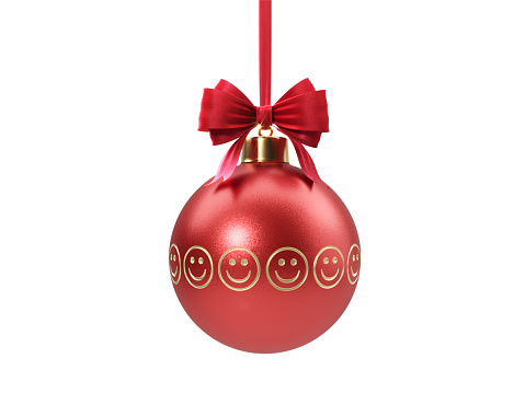 Smiley faces etched red Christmas bauble tied with red velvet ribbon over white background. Clipping path included. Horizontal composition with copy space. Great use for Christmas related concepts.