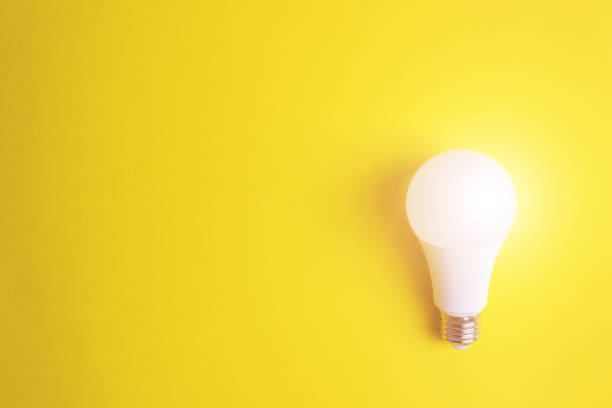 istock Glowing bulb on yellow background, uniqueness concept. Idea, innovation, creativity concept, design template, copy space. 1282904890