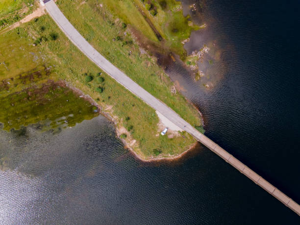istock zenithal view from a drone with a Bridge over the river with a way 1282906027