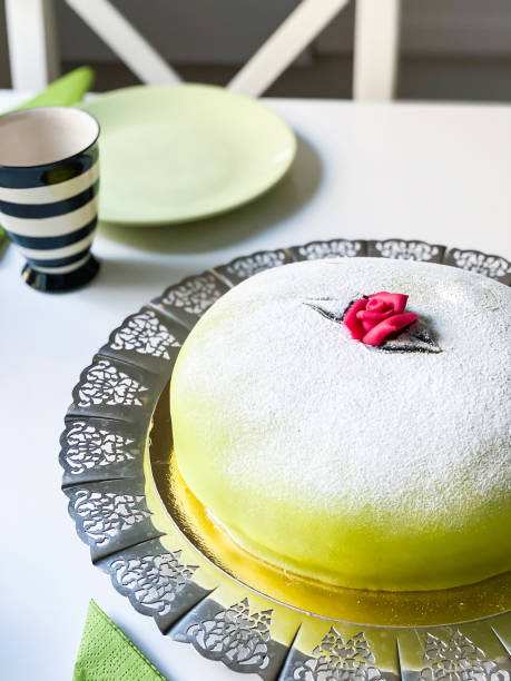 istock Green marzipan cake on silver cake plat. 1282906090