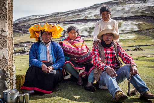 Upis, Peru: Portrait of local Quechua family in harsh outdoor setting.