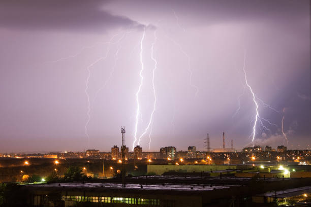istock Powerful lightning strike hits the city at night. A strong lightning strike over a dark gray sky hits the ground, illuminating the town. 1282907169