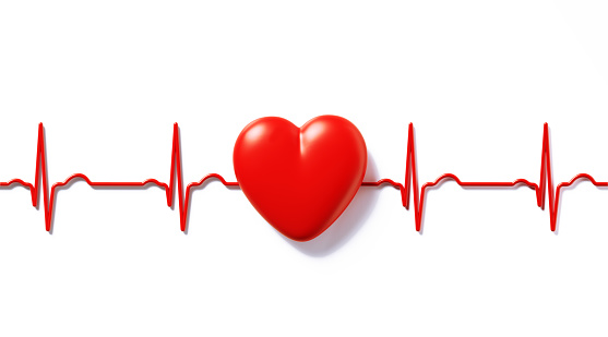 Red EKG line behind red heart on white background. Horizontal composition with copy space.