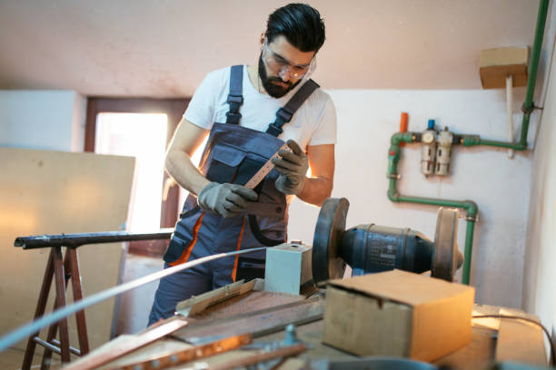 istock Male worker grinding metal plate in workshop 1282911606