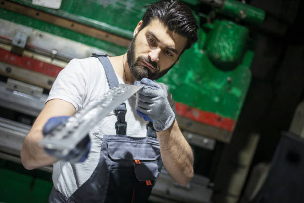istock Manual worker looking at metal part 1282911692